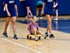 An athlete and peer mentor walk the track together as part of the Inclusive Sports and Fitness program.