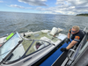 A Suffolk County Police Marine Bureau officer works alongside the partially submerged boat after all five people aboard were brought to safety Monday evening.  
