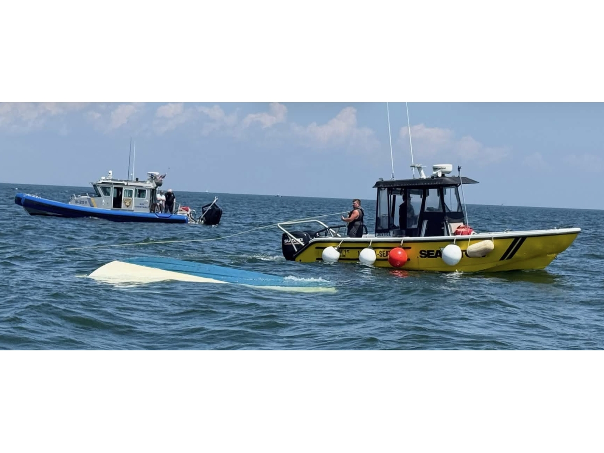 The operator was found clinging to the hull of an overturned 18-foot boat near Cranes Neck, town officials said.