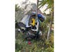 A heavily damaged 2008 Isuzu box truck is seen after it left Sunrise Highway and struck the center median and a pole near Exit 50A on Aug. 9, police said. One occupant had to be extricated from the cab.