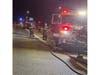 Islip firefighters work at the scene of a vehicle fire on the eastbound Southern State Parkway near Islip Avenue late Sunday night.