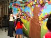 Students at O’Neill Elementary School add leaves to the school’s “Tree of Remembrance,” created to mark the 25th anniversary of the Sept. 11 attacks and reflect on kindness, unity and service.