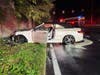 A damaged vehicle rests off the eastbound Sunrise Highway service road in Sayville after firefighters extinguished an engine compartment fire Wednesday morning.