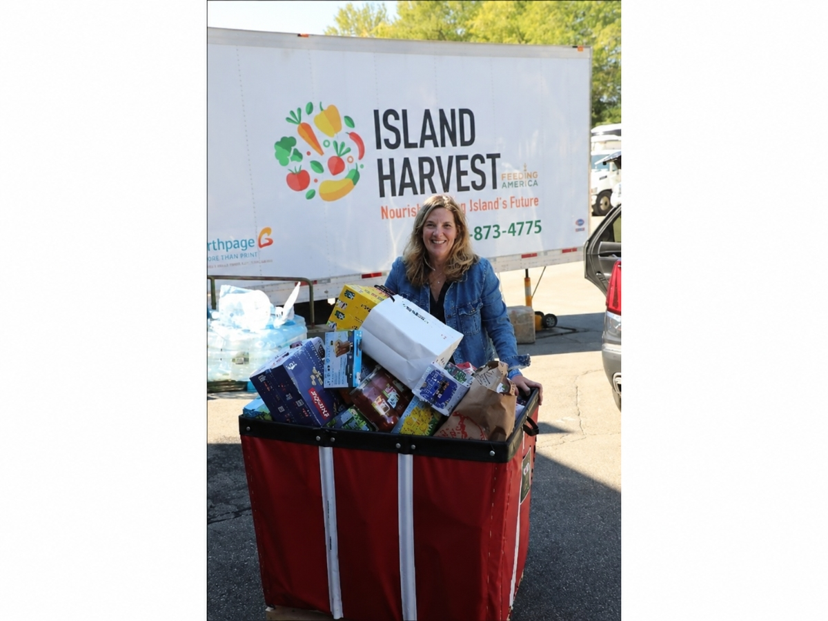 A Daniel Gale Sotheby’s International Realty volunteer delivers food donations to Island Harvest as part of the company’s annual September food drive, now in its fifth year.