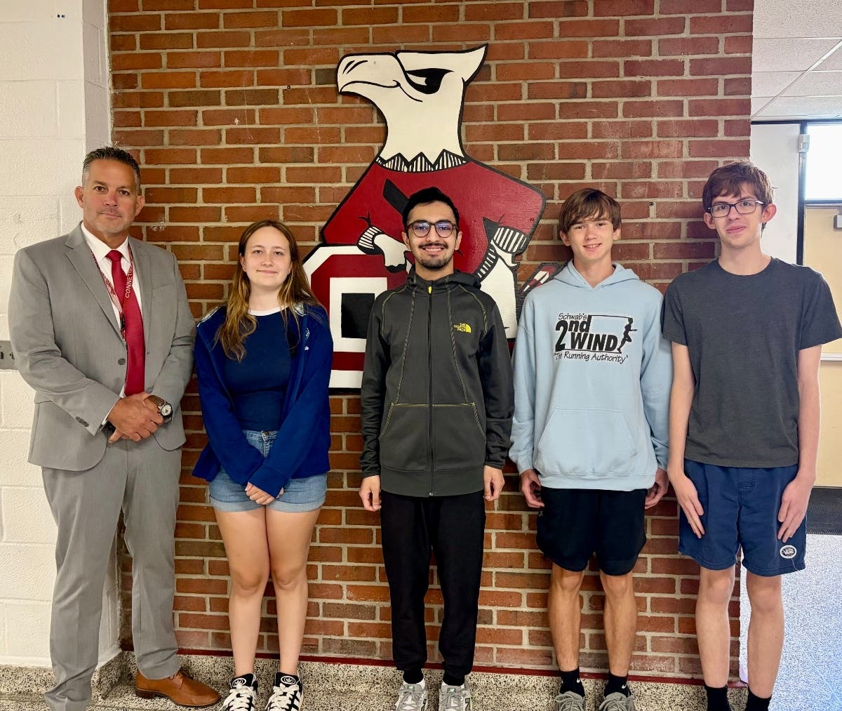 Connetquot High School Principal Michael Moran stands with National Merit Commended Students Stephanie Loughlin, Ashaz Moen, Kyle Callahan and Nathaniel Johnson.