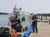 Suffolk County Police Marine Bureau personnel coordinate operations aboard a police vessel during the Smithtown Bay rescue exercise.