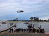 First responders gather at the Kings Park Bluff during a search-and-rescue exercise involving marine units and an Army National Guard helicopter.