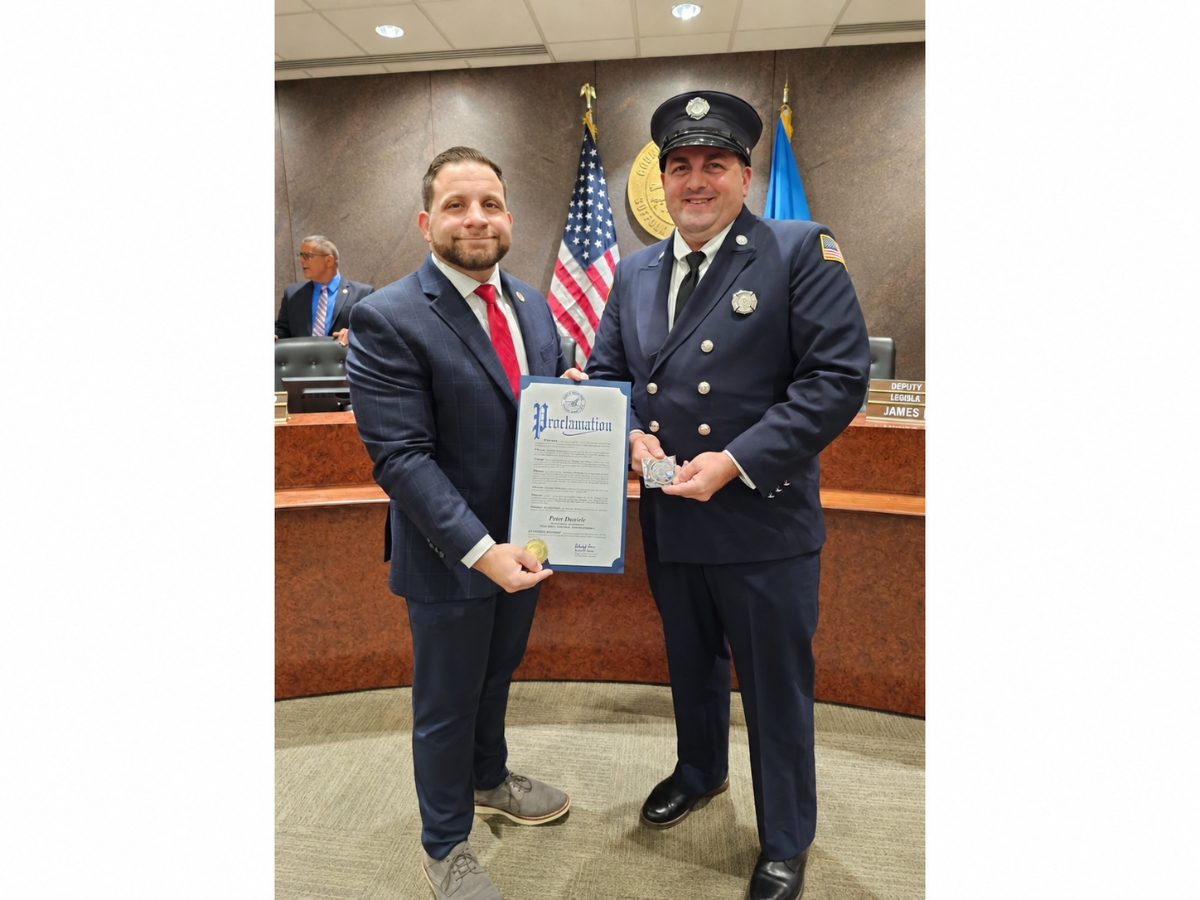 Legislator Richard “RJ” Renna, left, honors West Babylon Fire Department member Peter Daniele after naming him Firefighter of the Year for the 14th Legislative District during the county’s annual Volunteer Firefighter Recognition Ceremony in Hauppauge.