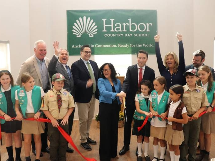 Harbor Country Day School students and community members celebrate the ribbon-cutting for the school's new three-story academic wing in St. James on Sept. 18.