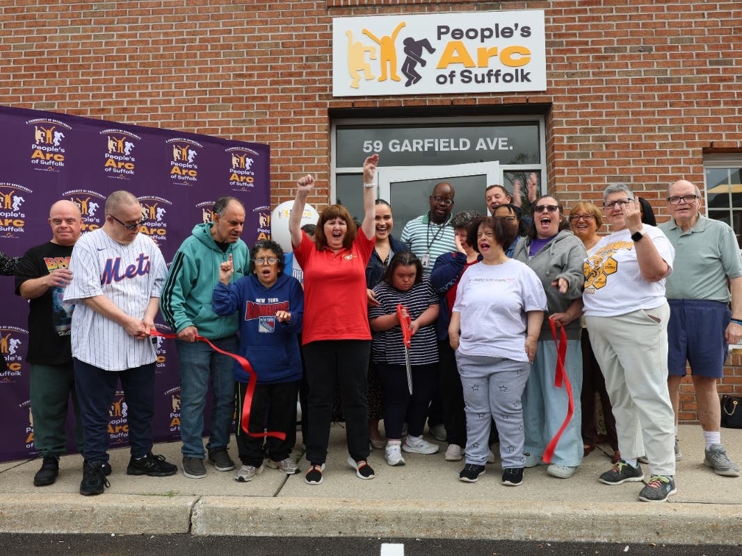 People’s Arc of Suffolk participants, staff and supporters celebrate the opening of the organization’s new Program Without Walls location at 59 Garfield Ave. in East Islip.