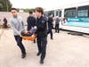 Students treat and transport simulated victims during a mass-casualty exercise featuring smoke, fire and multiple emergency scenes at the Nassau County Fire Service Academy.