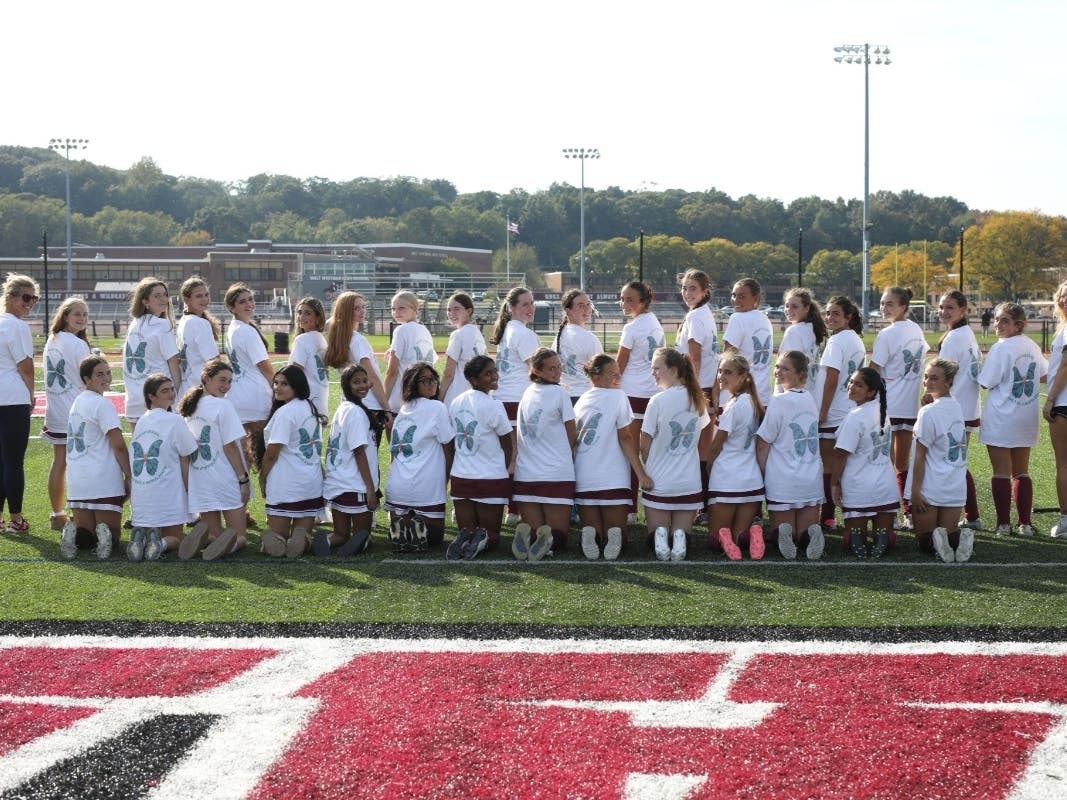 Walt Whitman High School's varsity and junior varsity field hockey players and coaches wear Morgan's Message T-shirts during their third annual dedication game on Oct. 2, raising awareness about student-athlete mental health.