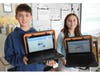 Jimmy Shehada and Paige Walsh show off their design skills with their custom-designed newspapers. 