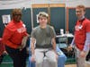 Dr. Sandra Nurse and medical student Kieran Mannion prepare Seaford High School junior Jackson Pignataro for his EKG.  