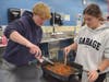 Sophomores Andrew Carlson and Daniella Foley preparing a batch of butter chicken in the international foods class. 