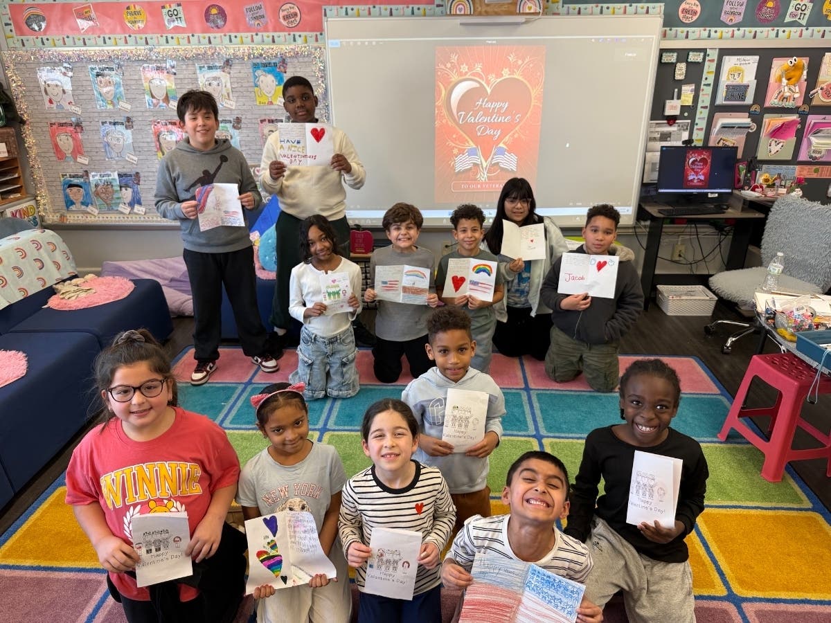 Steele Elementary School second graders in Nancy Aquino’s class, with some of the letters written for veterans. 