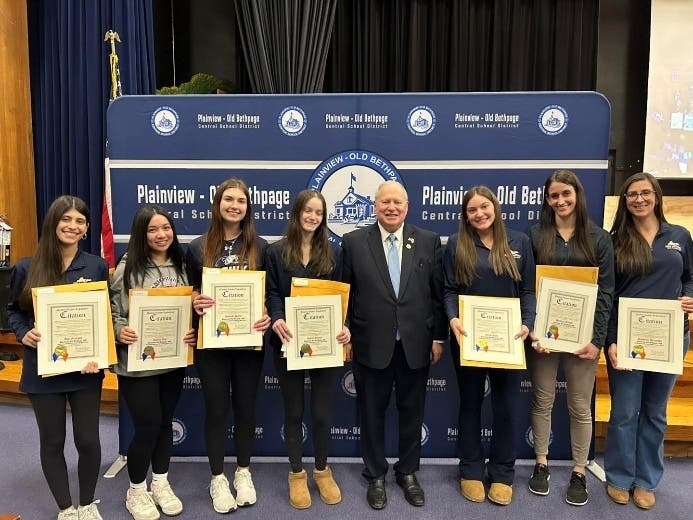 Nassau County Legislator Arnold Drucker, with members of the Plainview-Old Bethpage volleyball team. 