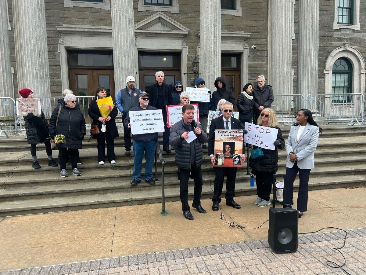 Protestors on the steps of the Nassau County Executive and Legislative Building demanding the release of opioid settlement funds Monday. 