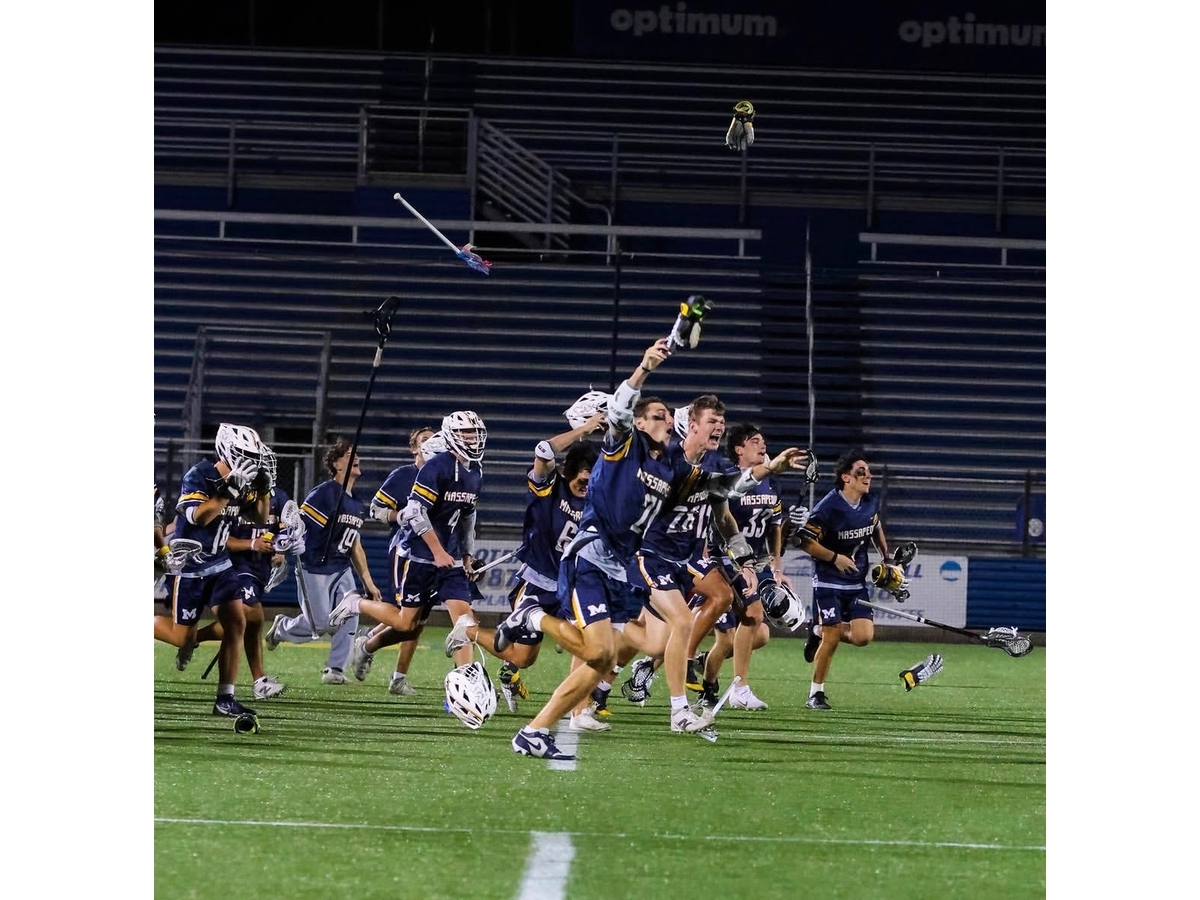 Massapequa boys' lacrosse storms the field after a county championship win over Syosset. 