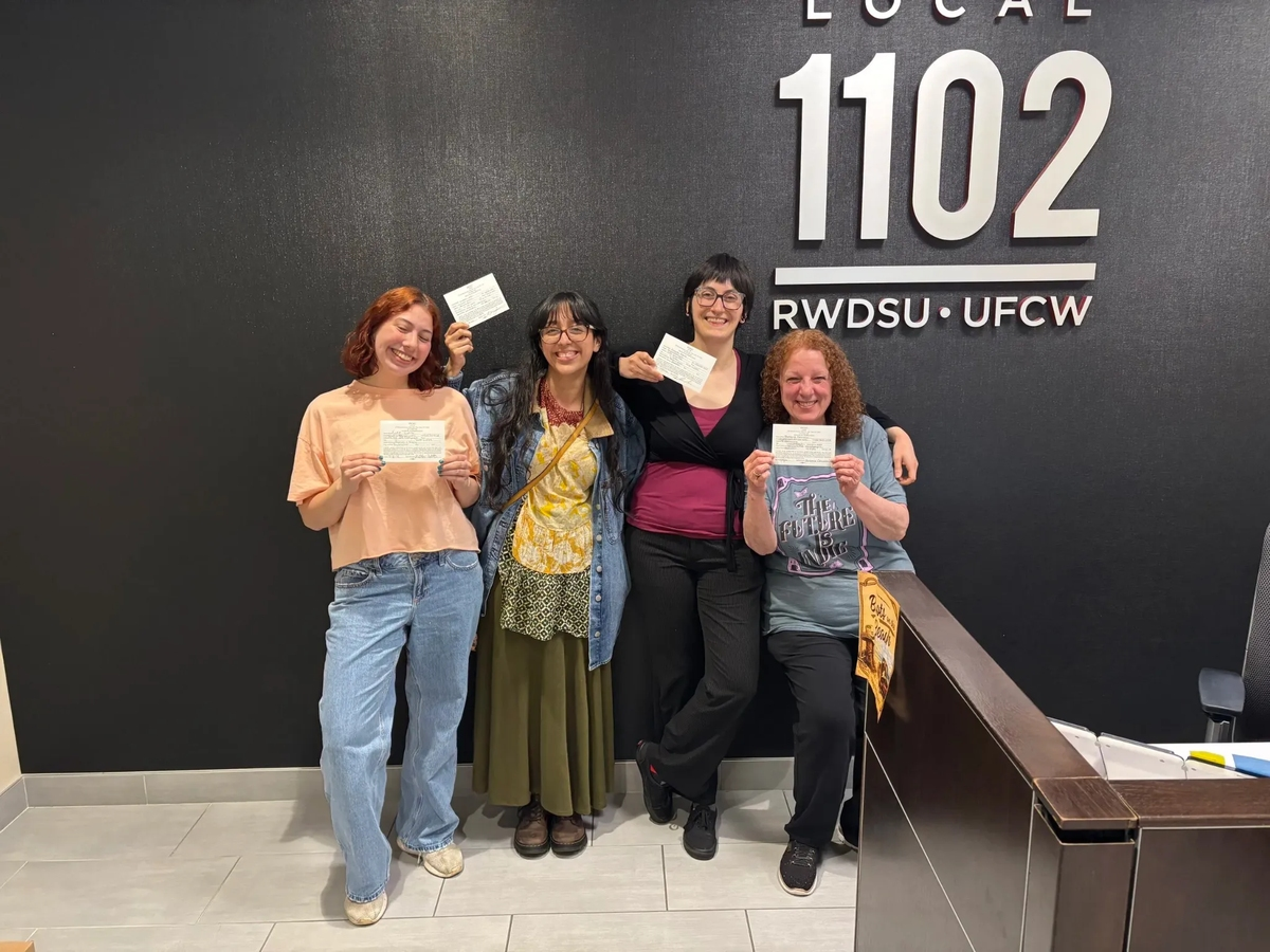 Members of the staff at Massapequa Park's Barnes & Noble location at the RWDSU Local 1102 office, union authorization cards in hand.