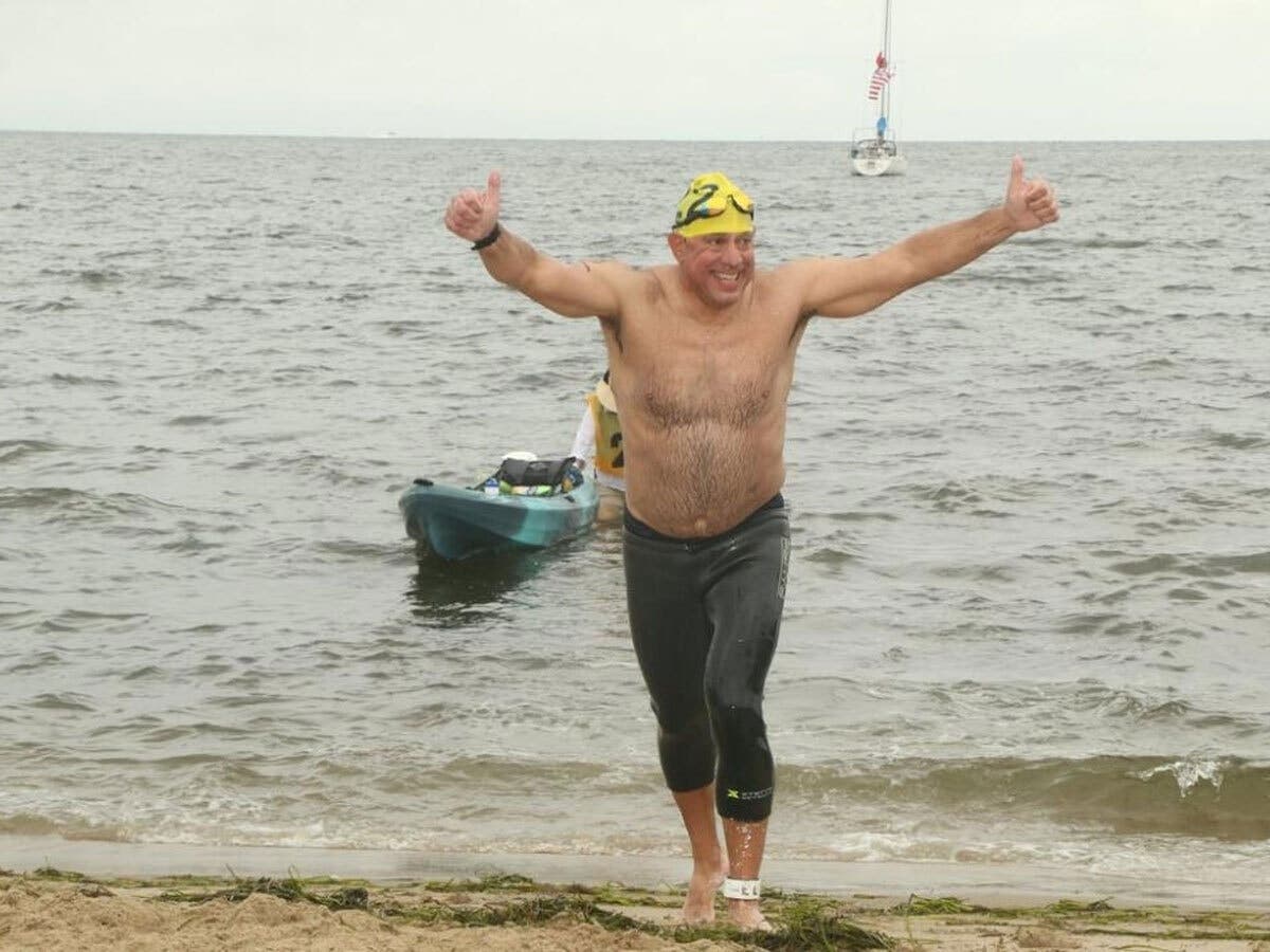 Keith Drayer exits the water after nine miles of swimming across two days.