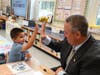 Superintendent Dr. William Brennan shares a high five with kindergartner Joseph
Cacioppo at Fairfield Elementary School.