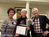Dorothy Gaboda accepts the Women Helping Women Award from Kathy Meyer, past SIIR president, with her husband, Bill.