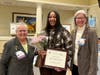 Deanna Bembury accepts the Live Your Dream Award from Jenny Lichtner, SIIR president, and Marlene Piasecki, Past President.