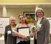 Desiree Delvalle accepts the Ginny Cooper Live Your Dream Award from Jenny Lichtner, SIIR president, and Marlene Piasecki, Past President.
