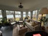 Home four offers a spacious sitting area filled with plants overlooking Roberts Cove.