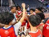 Team huddle moment as players and coaches come together: locked in and ready for the game.