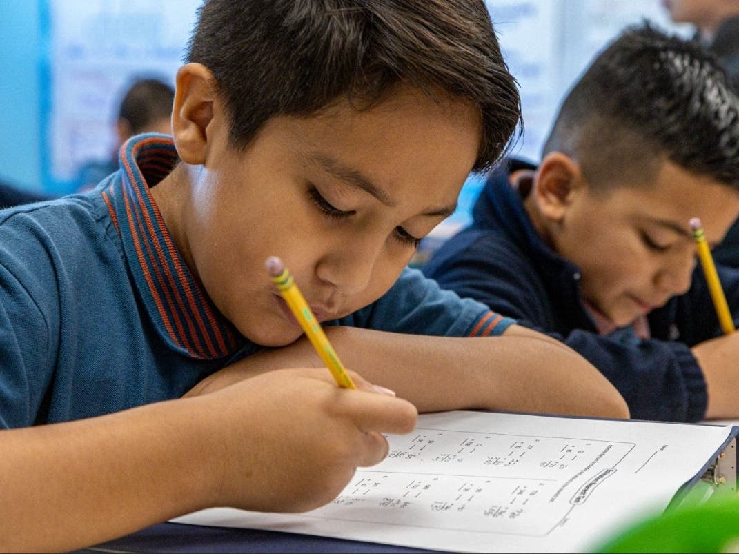 Focused and collaborative, these students dive deep into their math assignment.