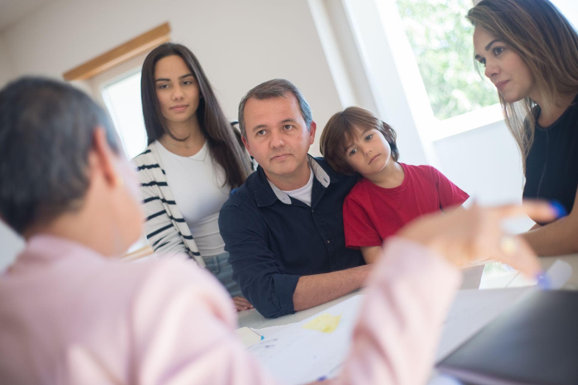 Family sitting together looking concerned, discussing detox options