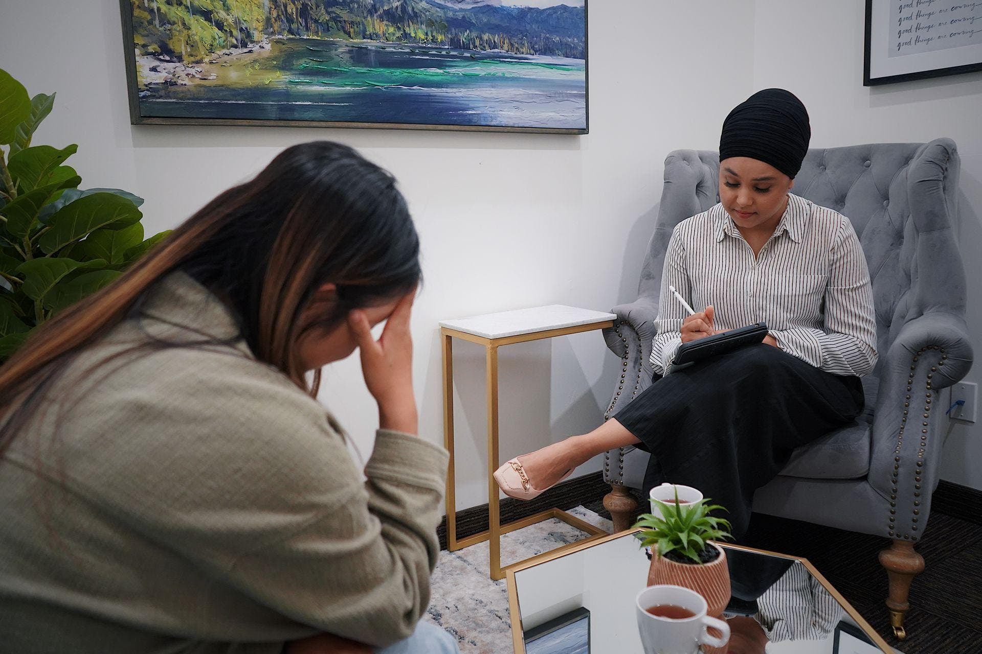 : A clinician listening closely to a client during a counseling session