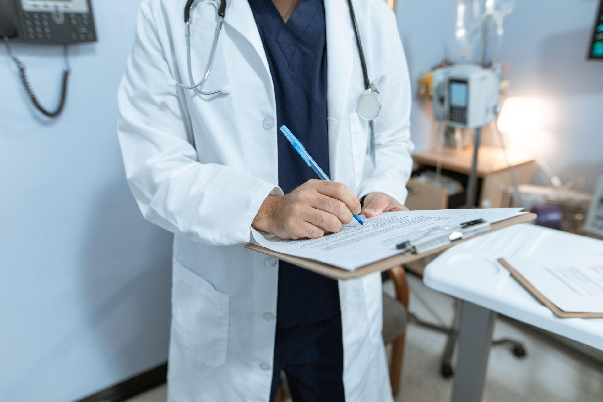 Medical professional reviewing a patient chart during clinical care planning.