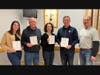 The 4 Leaf Clovers, last year’s Rookie of the Year team, earned second place at the TSF Trivia Team Challenge. From left, Sheila Eriksen, Frank Cassidy, Barbara Cassidy, and Tim Sweeney are congratulated by TSF President T.J. White.