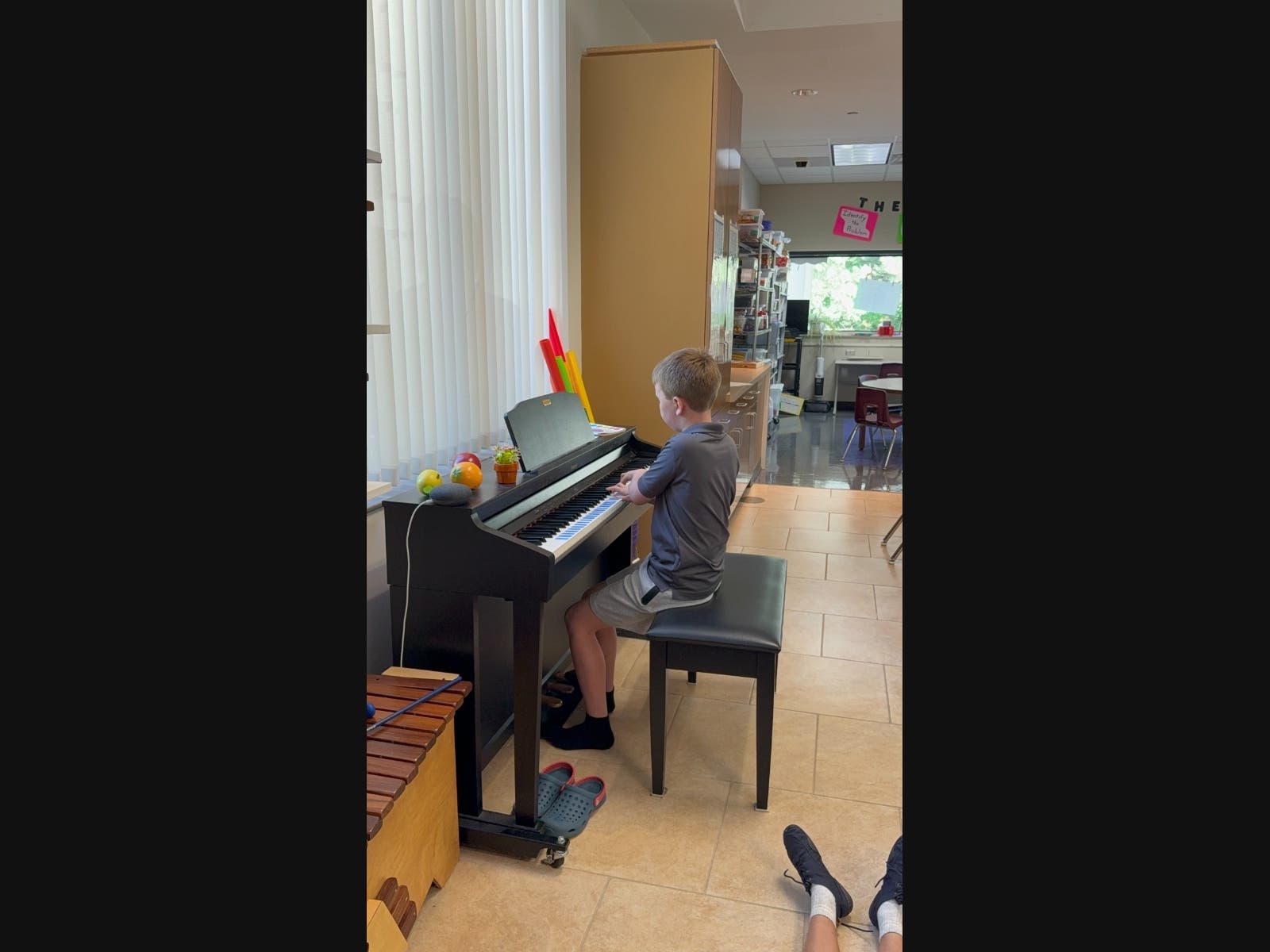 A student is at the piano during a music class at Vanguard Gifted Academy in Batavia, IL.