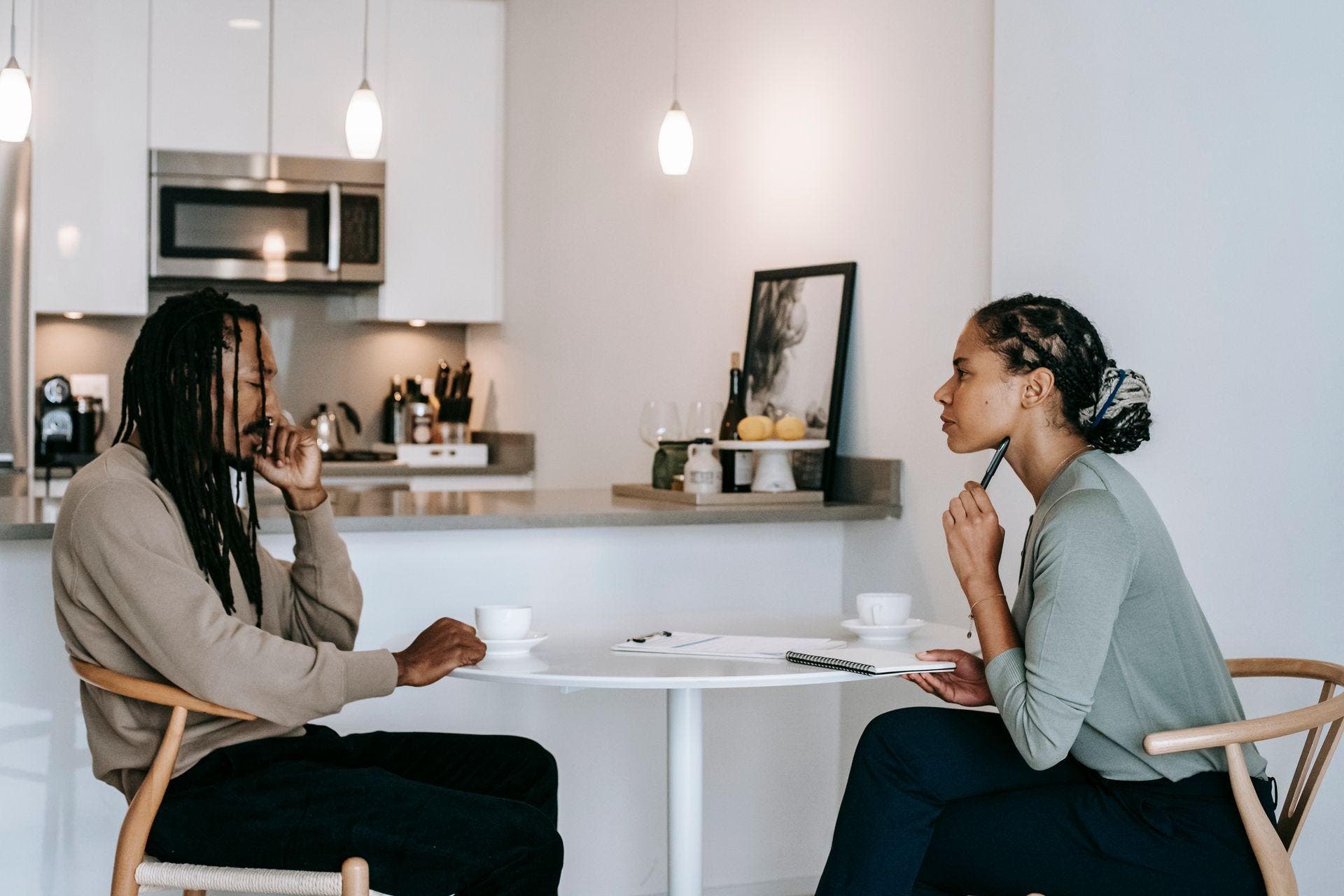 Two people in conversation at a table