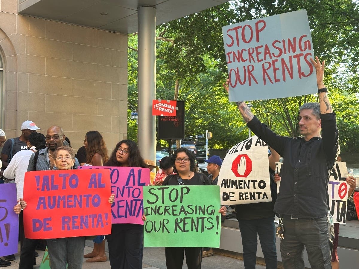 People hold signs during the New York City Rent Guidelines Board’s June vote on rent-stabilized lease increases.