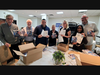Almost done, Stamford Rotary members Alan Lang, Michael Zucker, Alex Santos, Judy Ducharme, Shivonne Mathison and Matt Stendardi wrap up packing dozens of boxes of dictionaries. 
