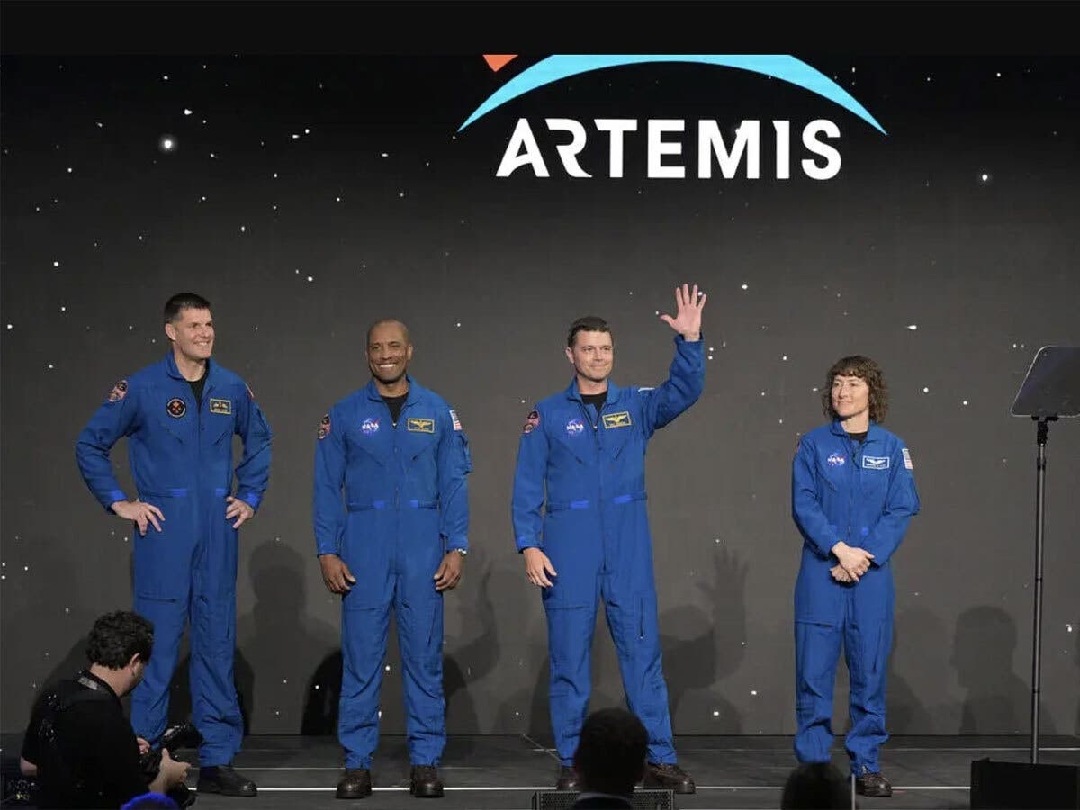 Canadian Space Agency astronaut Jeremy Hansen (from left) and NASA astronauts Victor Glover, Reid Wiseman, and Christina Koch greet the crowd at Ellington Field near NASA’s Johnson Space Center on Monday, April 3, 2023.