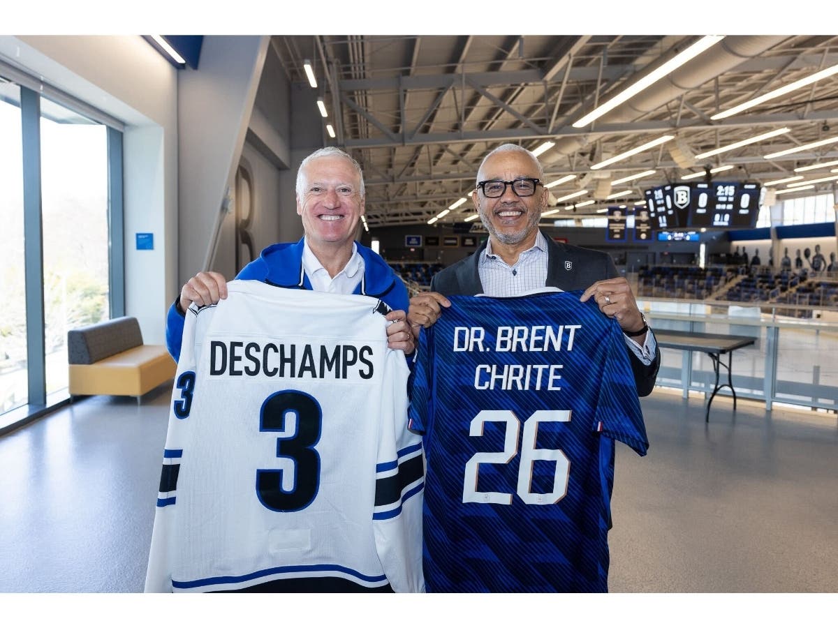 French national soccer team coach Didier Deschamps, left, holds a Bentley University jersey this week while Bentley President E. LaBrent Chrite displays his own jersey from the team nicknamed "Les Bleus."