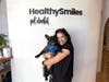 Raysa Felix, Founder & CEO of HealthySmiles Pet Dental with a French Bulldog whose teeth she just cleaned