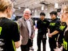 Dave Grewell, dean of NIU's College of Engineering and Engineering Technology, greets members of Got Robot?, an Elgin-based team that placed 10th out of the 48 teams. Grewell oversaw engineering staff and student organizations who supported the event.