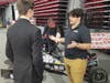 Livio Letteriello, a leader for Huskie Motorsports, speaks with a high school student during a lull in FIRST championship action. In addition to Huskie Motorsports, NIU Supermileage and and the NIU Robotics Club set up displays.