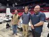 Joseph Rayner (left) and Scott Crane present their senior design project on May 1, 2026, joined by ATI sponsor Dustin Smith (right), at the NIU Convocation Center. A graduate of St. Charles North High School, Rayner first attended Elgin Community College.