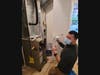 An Angel's Duct Cleaning employee prepares an ultraviolet light used to destroy viruses, bacteria and allergens in duct work.
