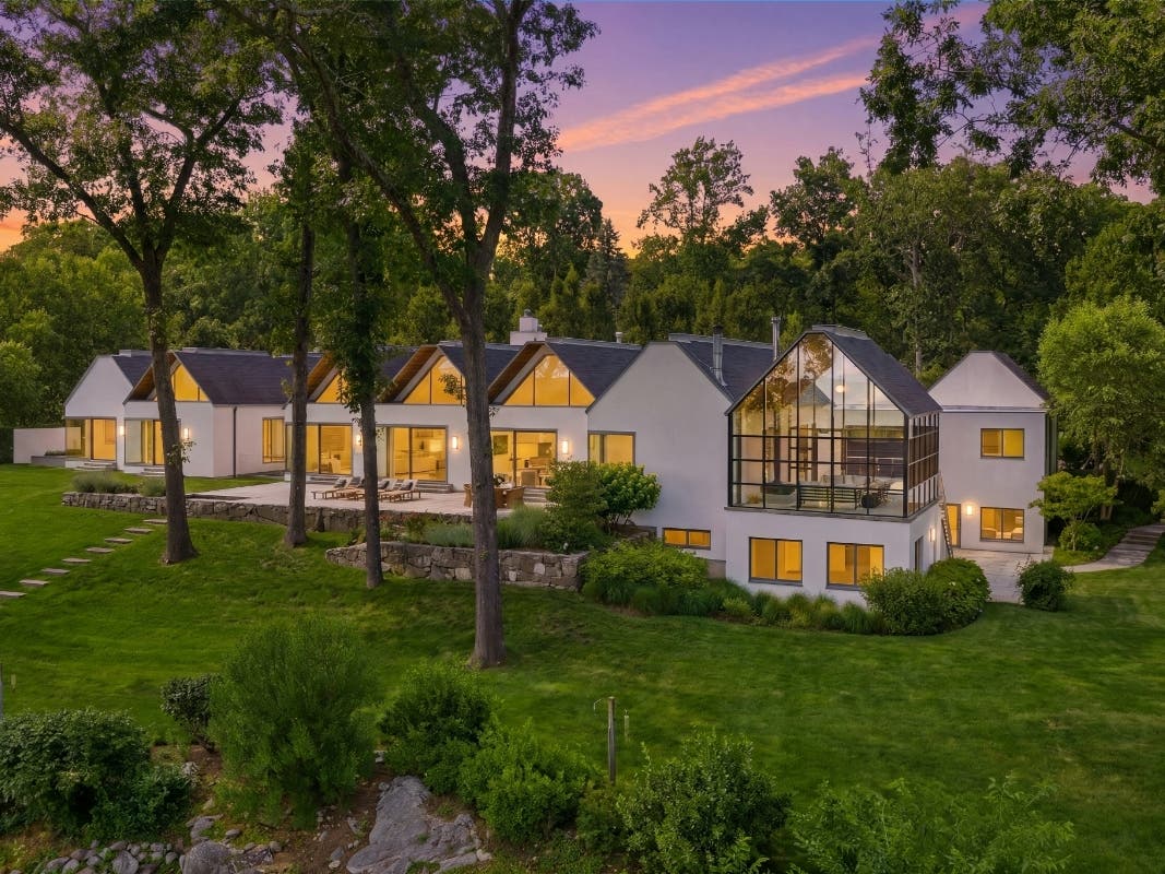 The "Origami House" at 10 Dragonwood Lane in Weston is listed for $6.5 million. The 15.57-acre estate features a koi pond that flows beneath part of the home and was previously owned by musician and filmmaker Rob Zombie.