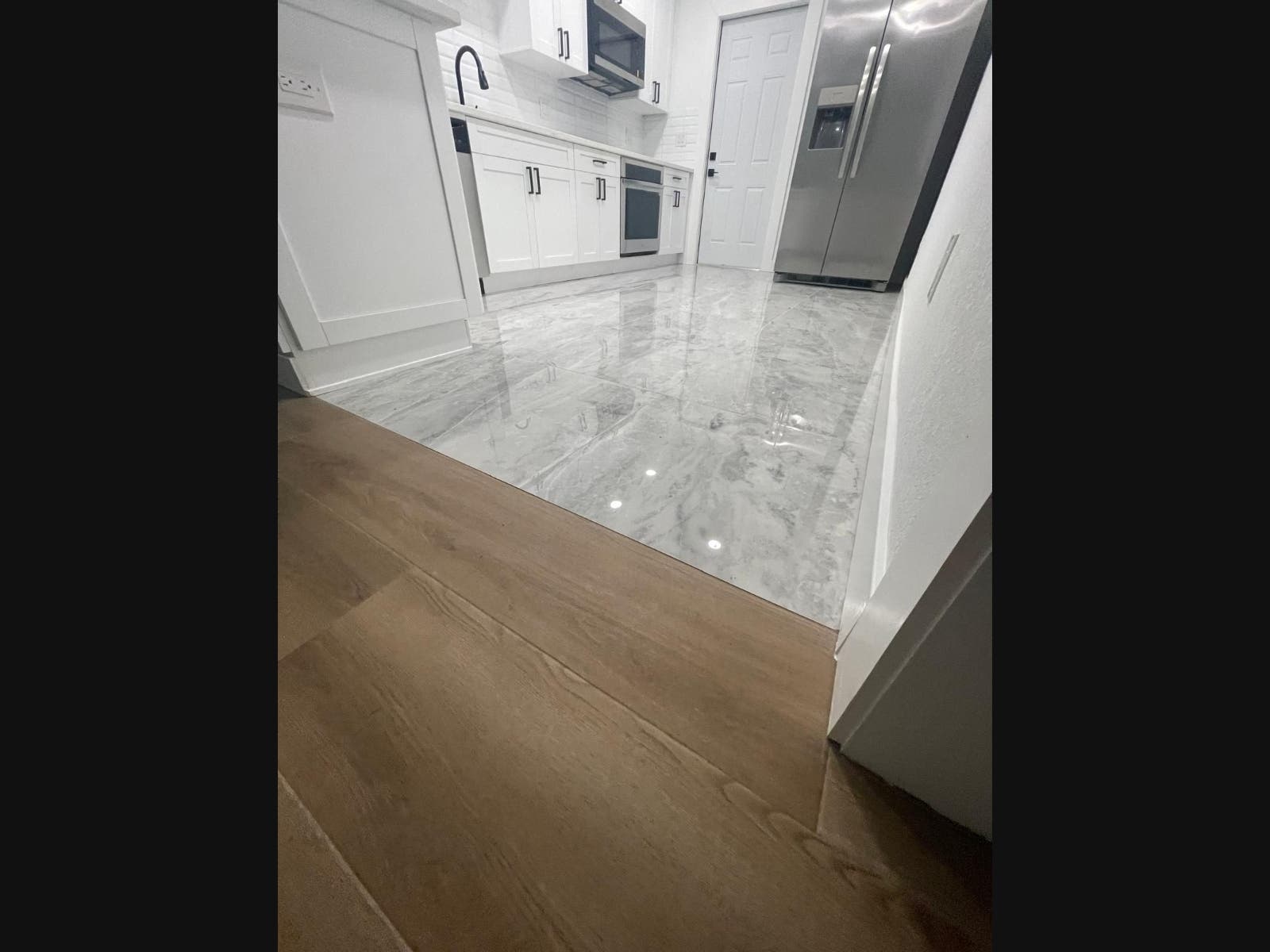 Professional tile floor transition installed between two flooring surfaces in a Tampa home.