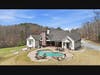 Entertainment galore, heated saltwater pool with waterfall, stone fire pit, outdoor brick fireplace, and covered sitting / entertaining area. 